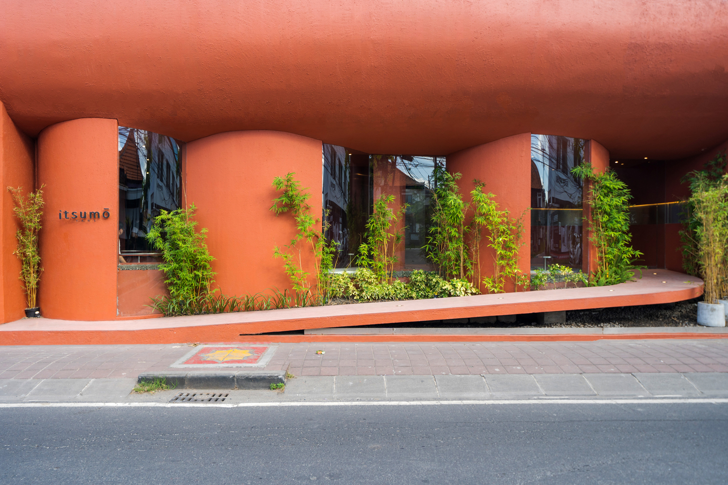 Savor Sweet Moments at The Merlot Pods, A Vibrant Red Stucco Building