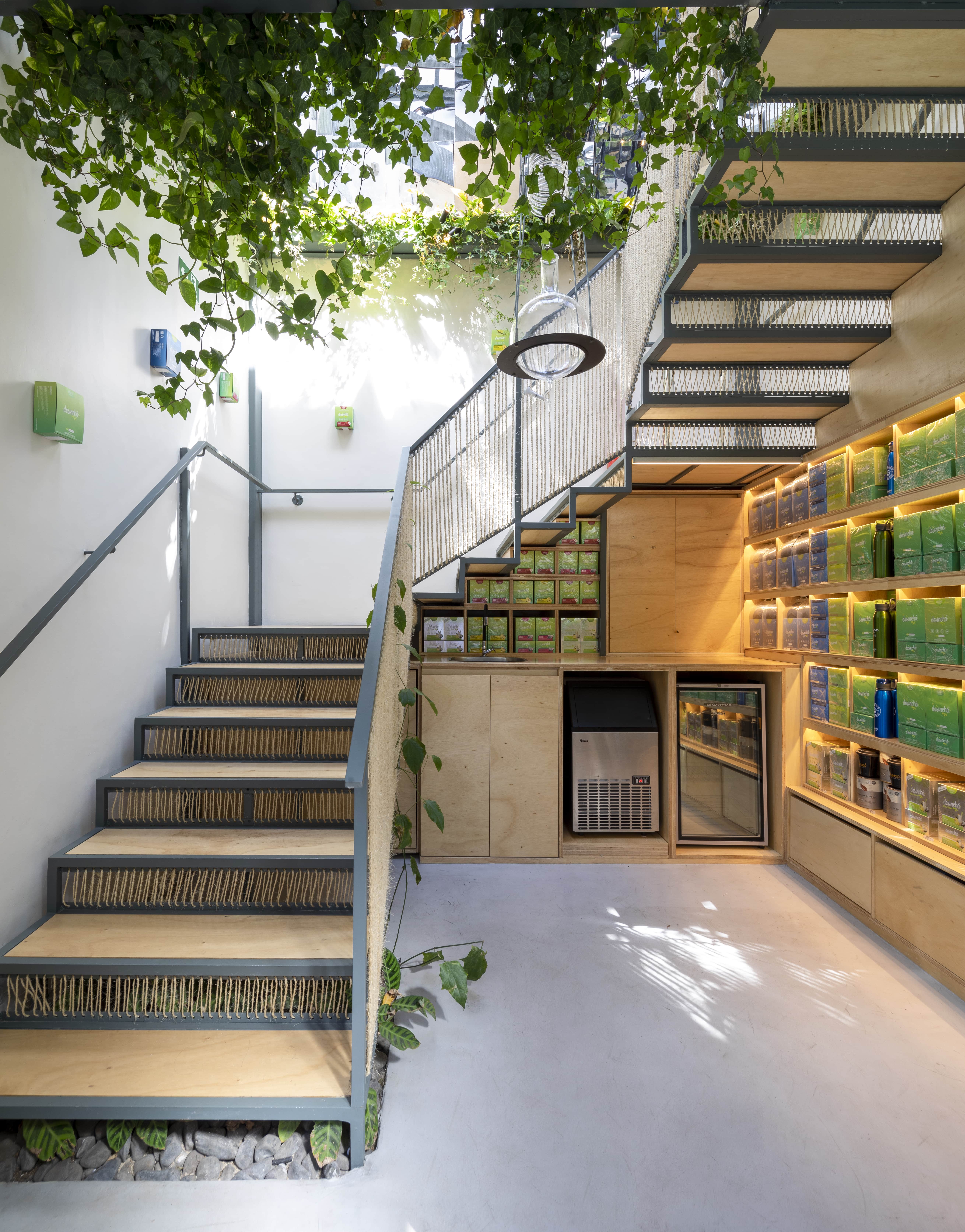 The ground floor of the shop with a wide staircase that connects it directly to the upper floor