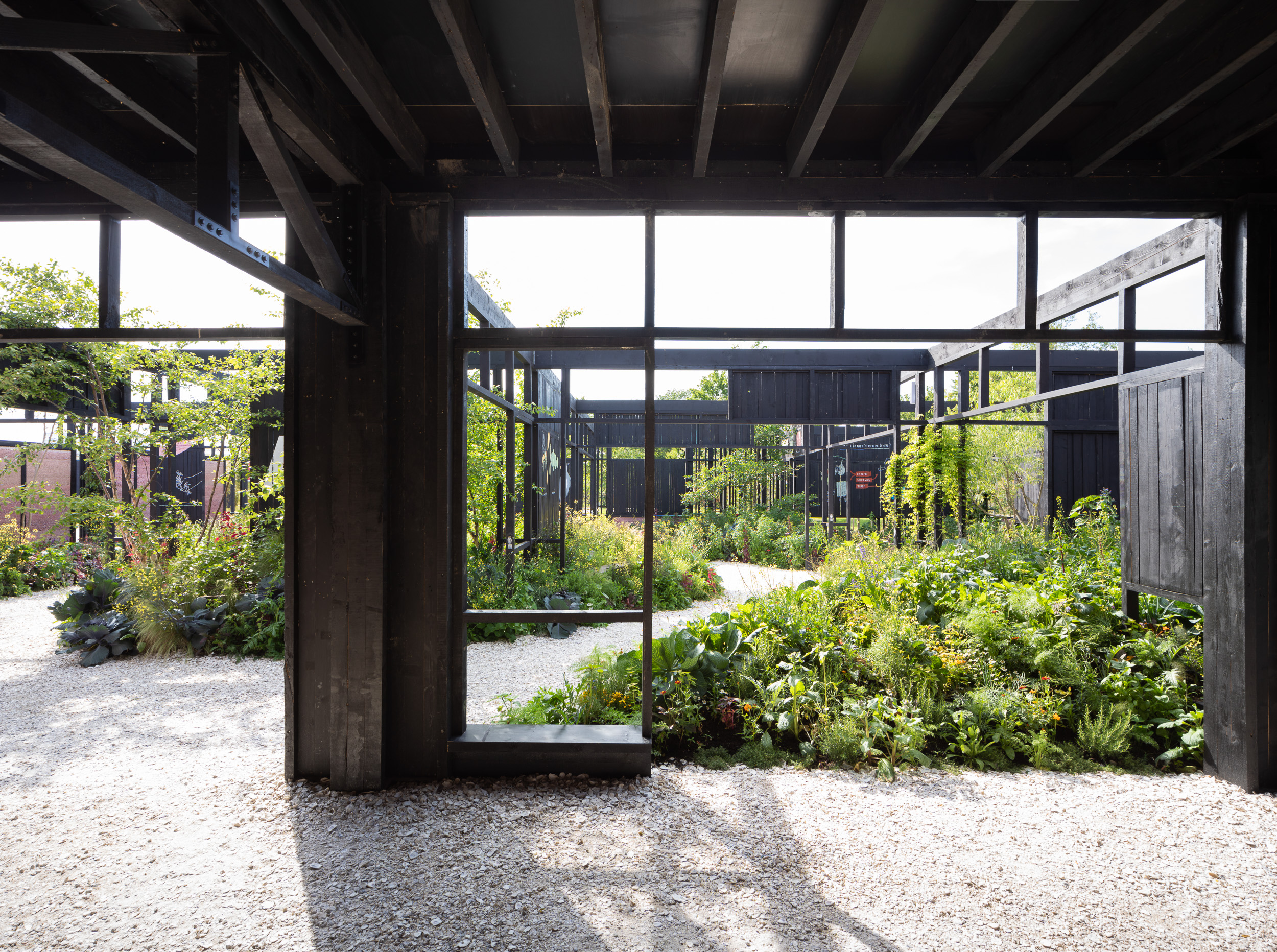 The wooden trusses and frames that make up this modular building are lined with a black layer of the hemp plant