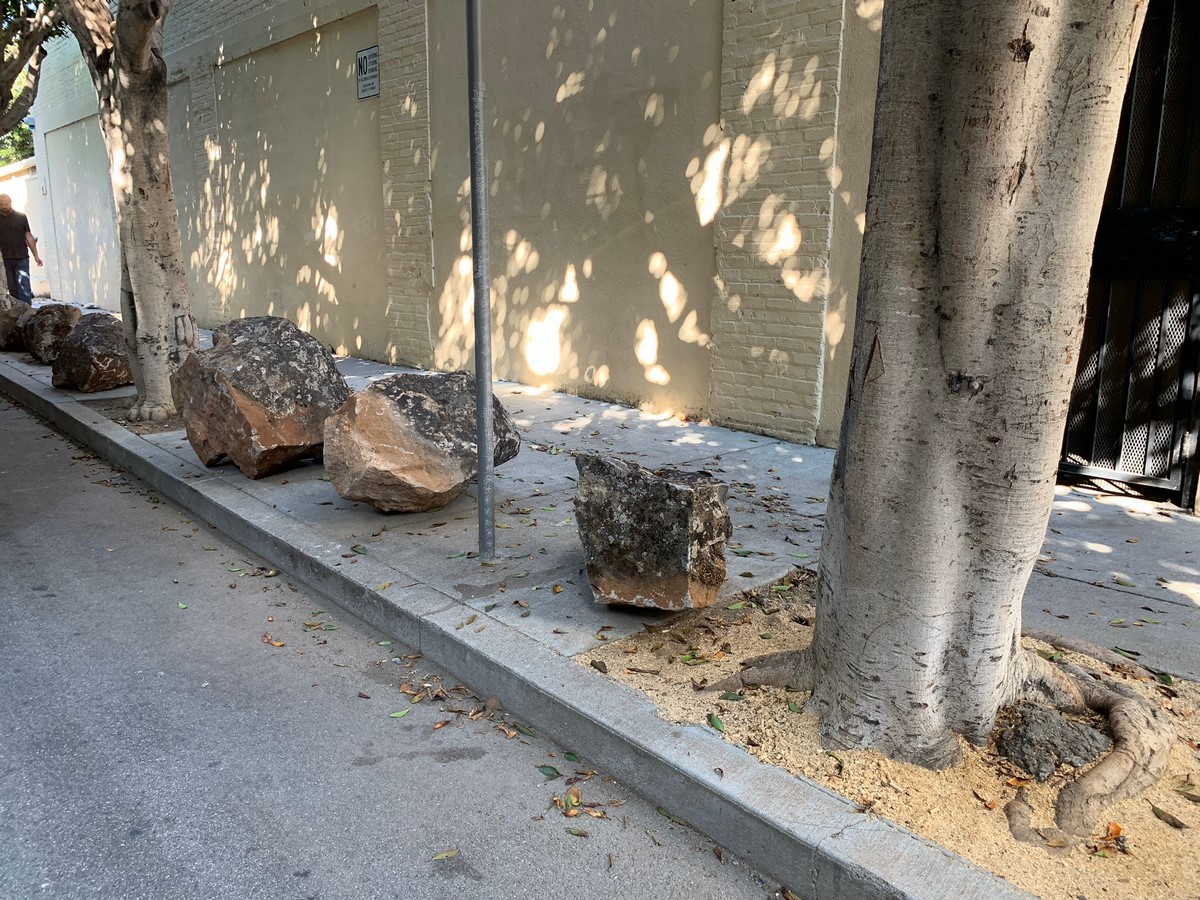 These boulders are placed along the sidewalk to prevent the homeless from settling there