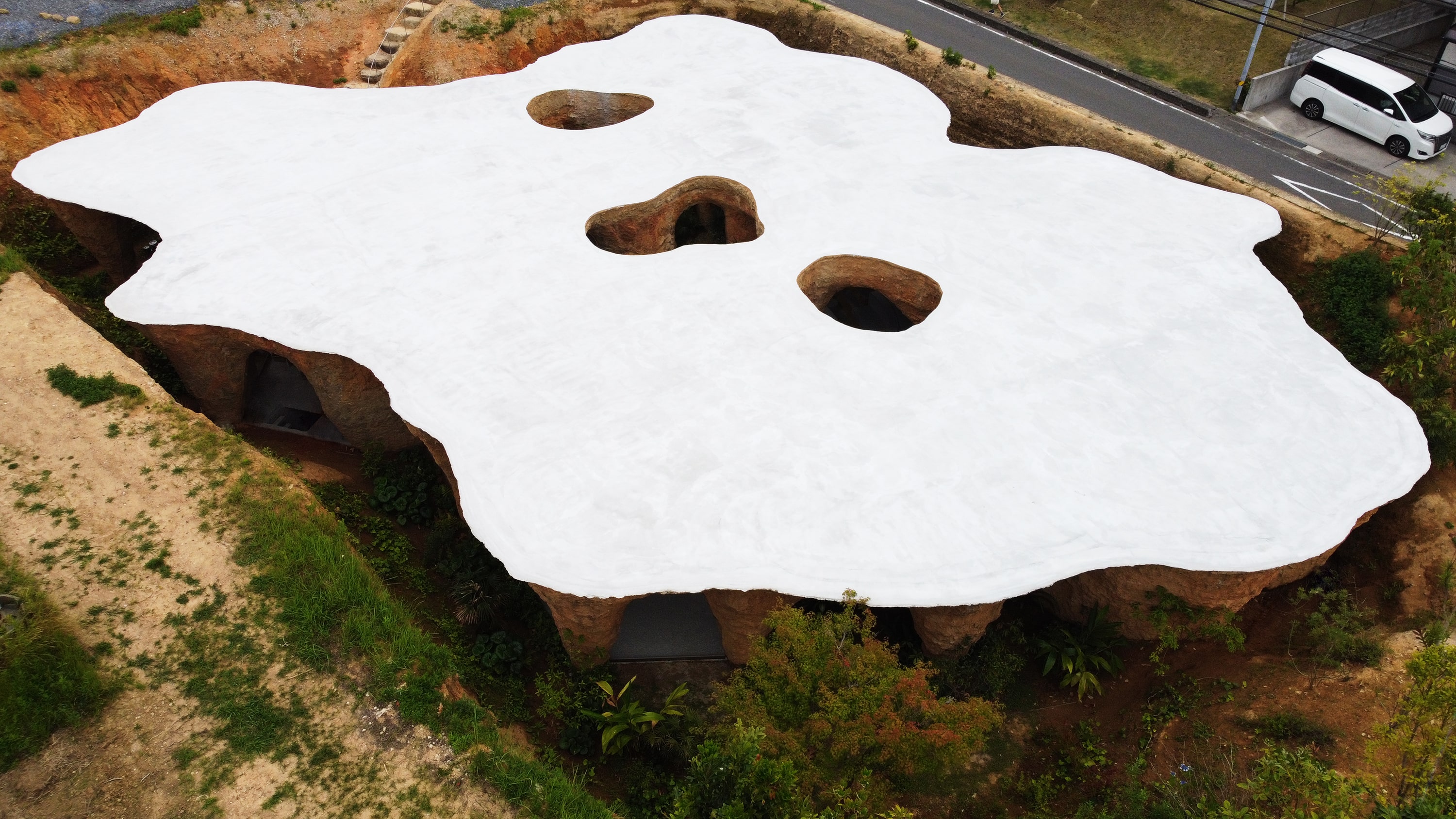 The white corrugated concrete roof contrasts with the inside of the building