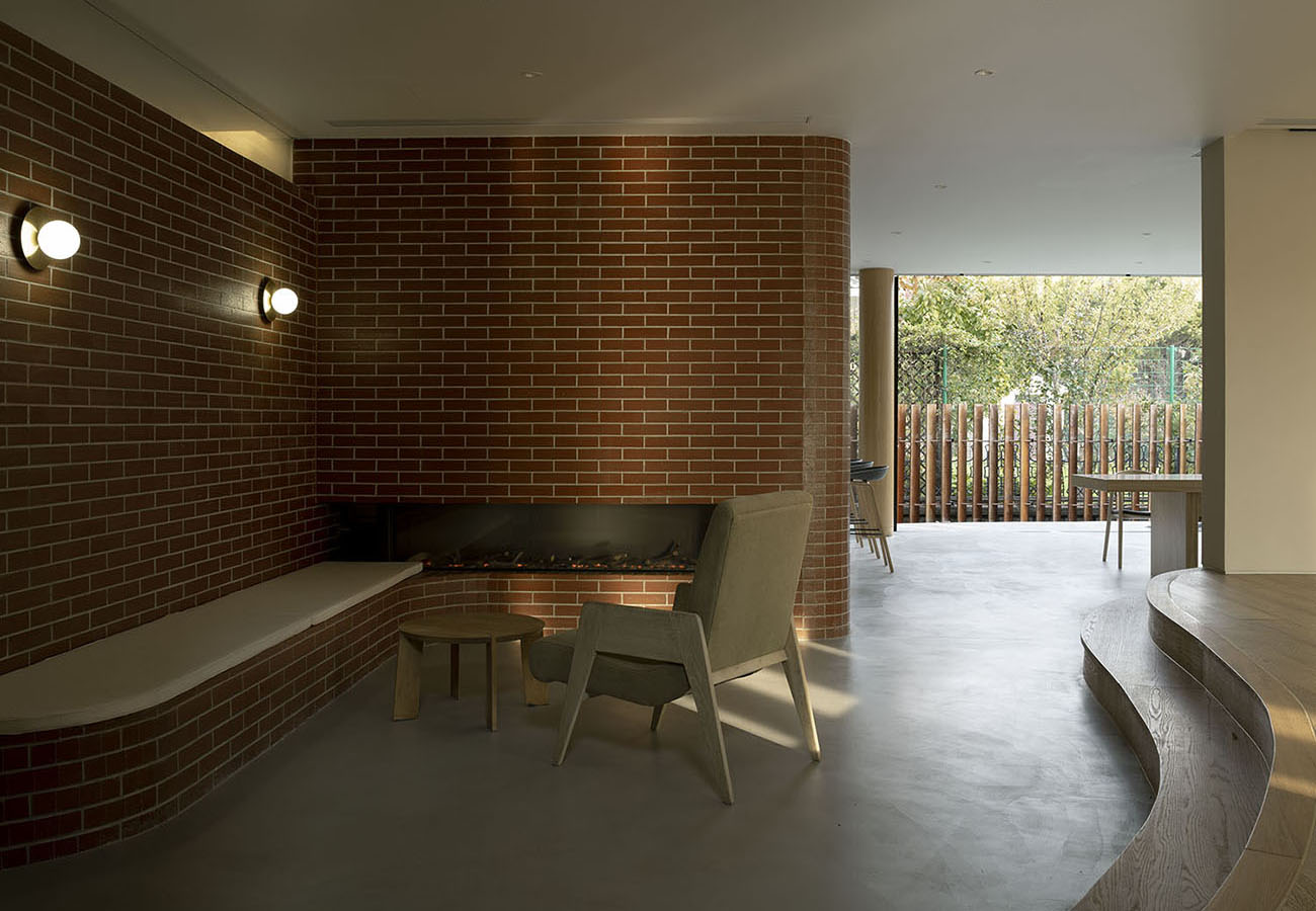 KiKi ARCHi continues the red brick touch from the exterior to the interior of the house