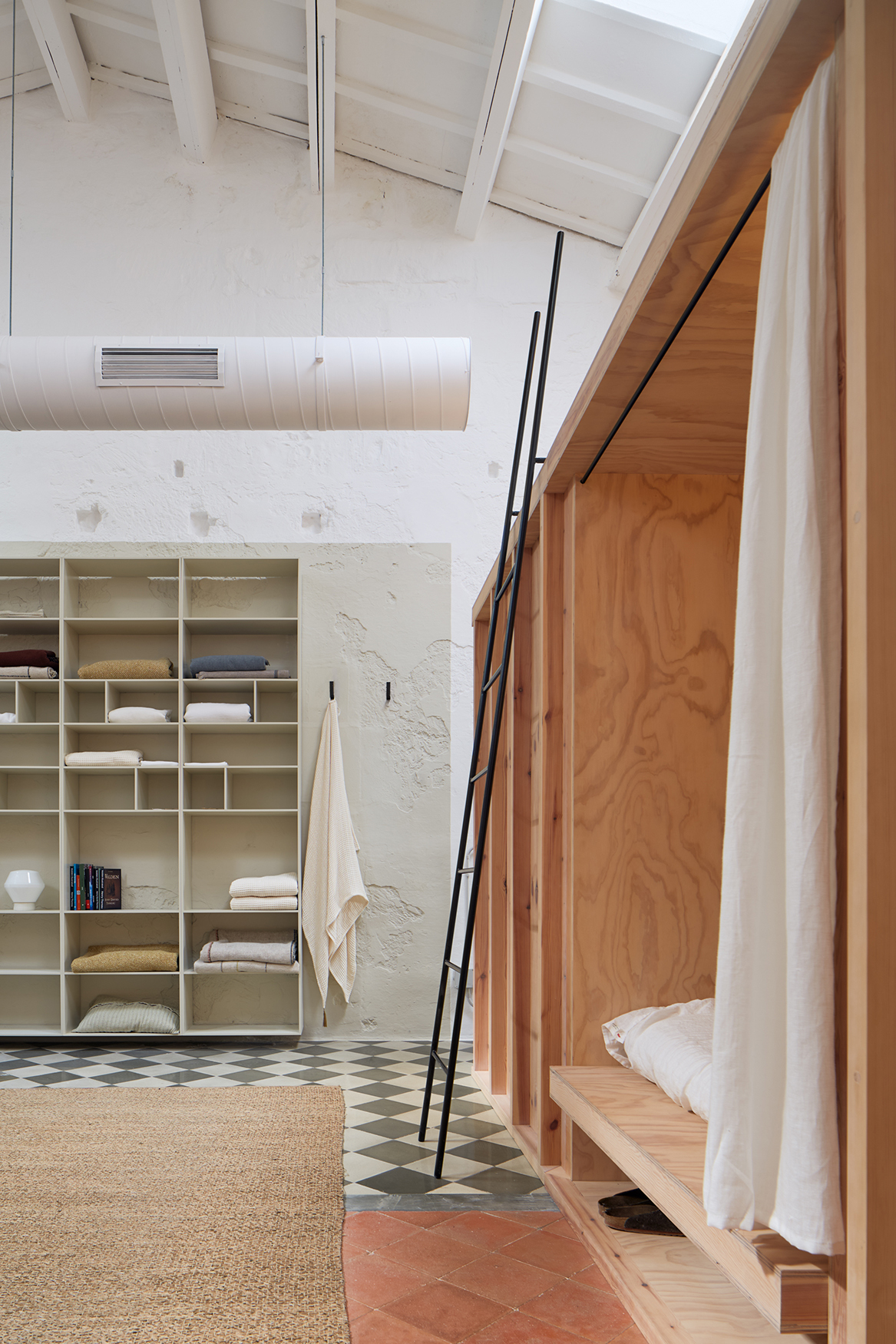 The interior of the first floor is filled with touches of wood, including its long bookshelves