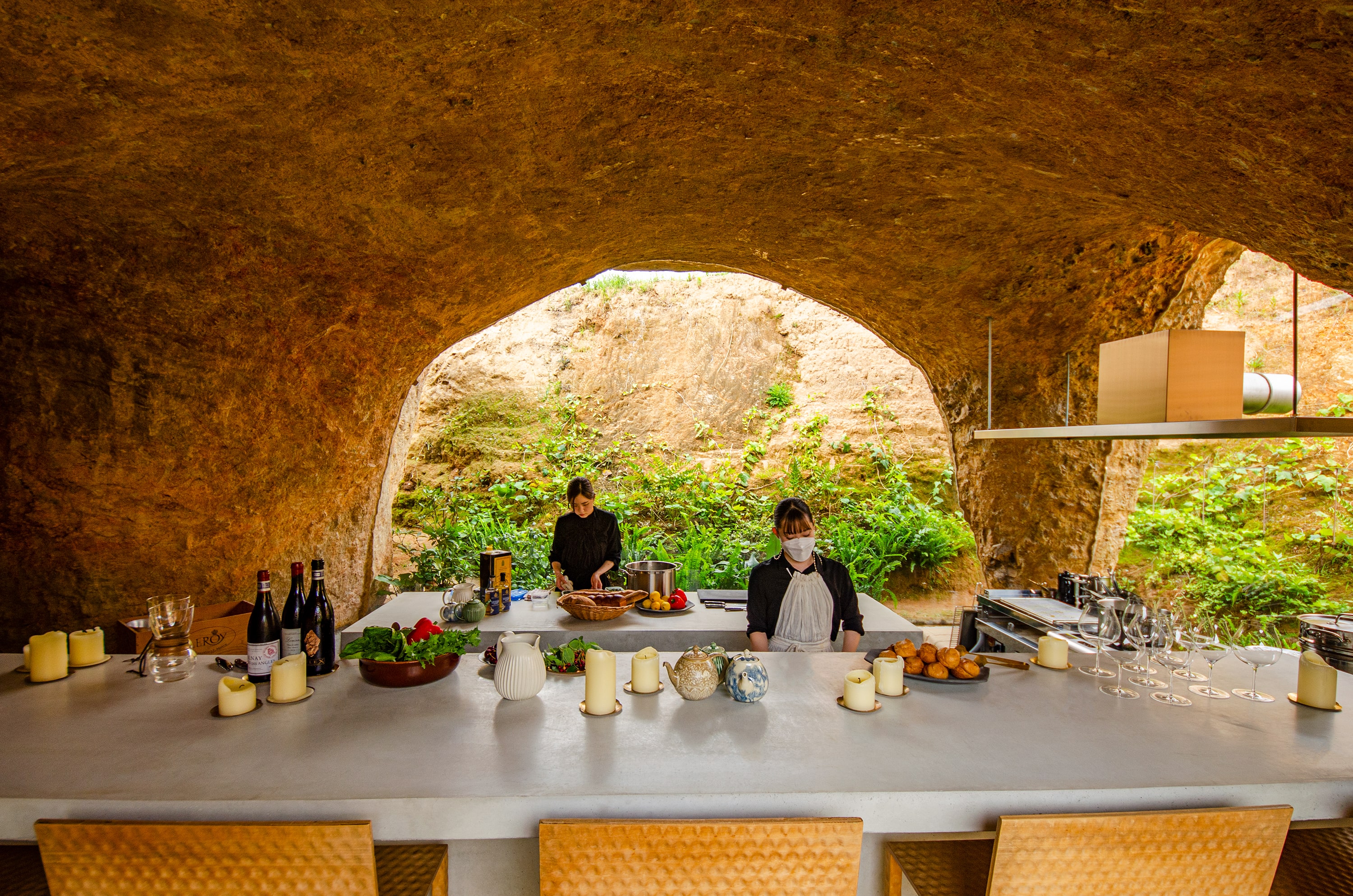 The main room in the restaurant is equipped with a long concrete table to serve guests