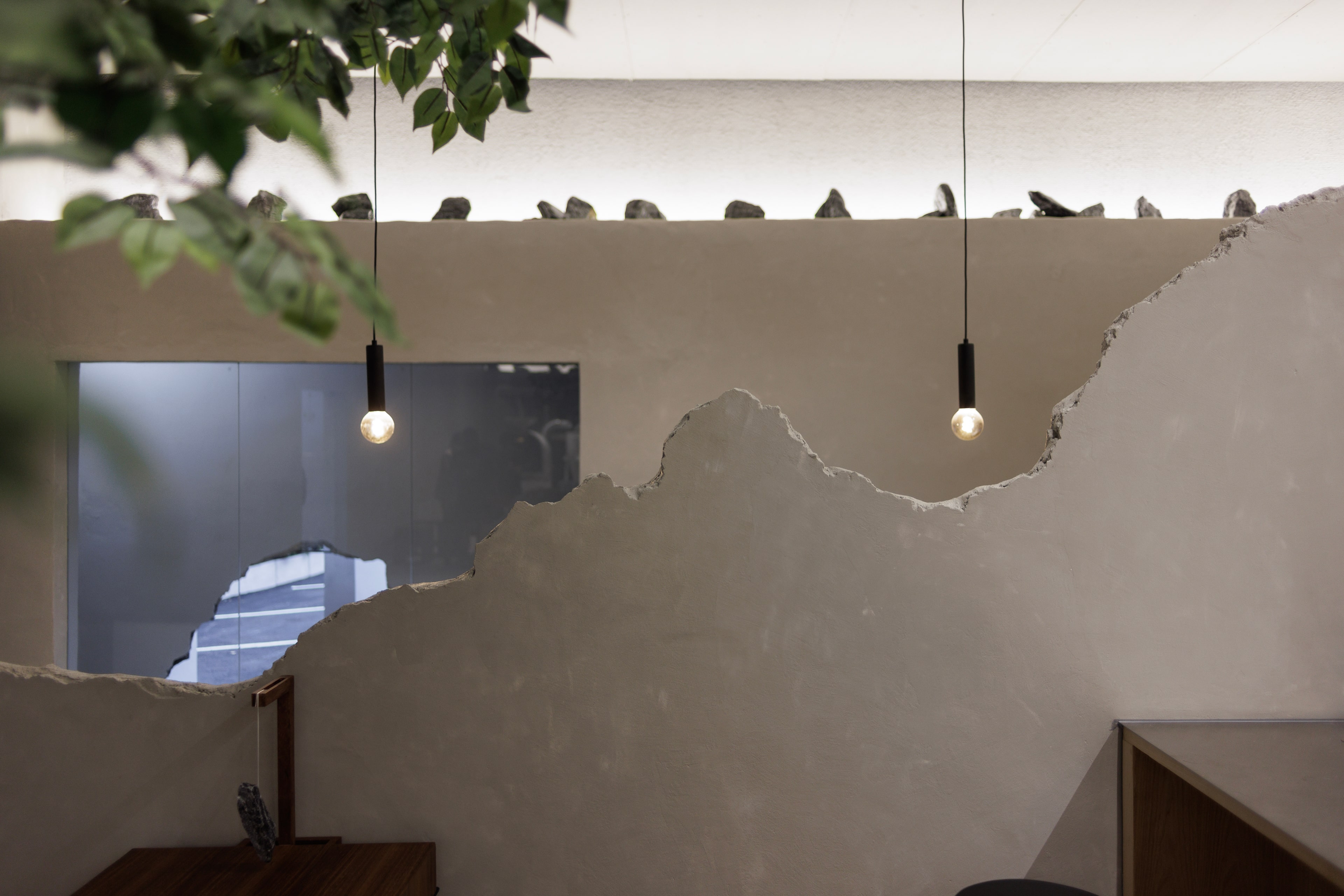 An incomplete wall separating the two areas in the cafÃ©'s interior