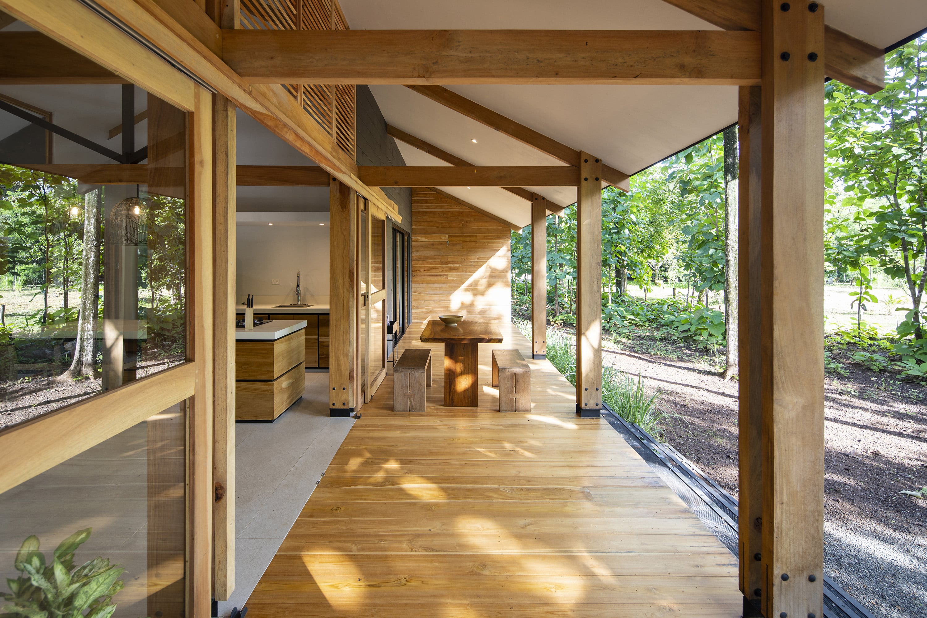 The wooden terrace jutted into the house, in the shade of the roof