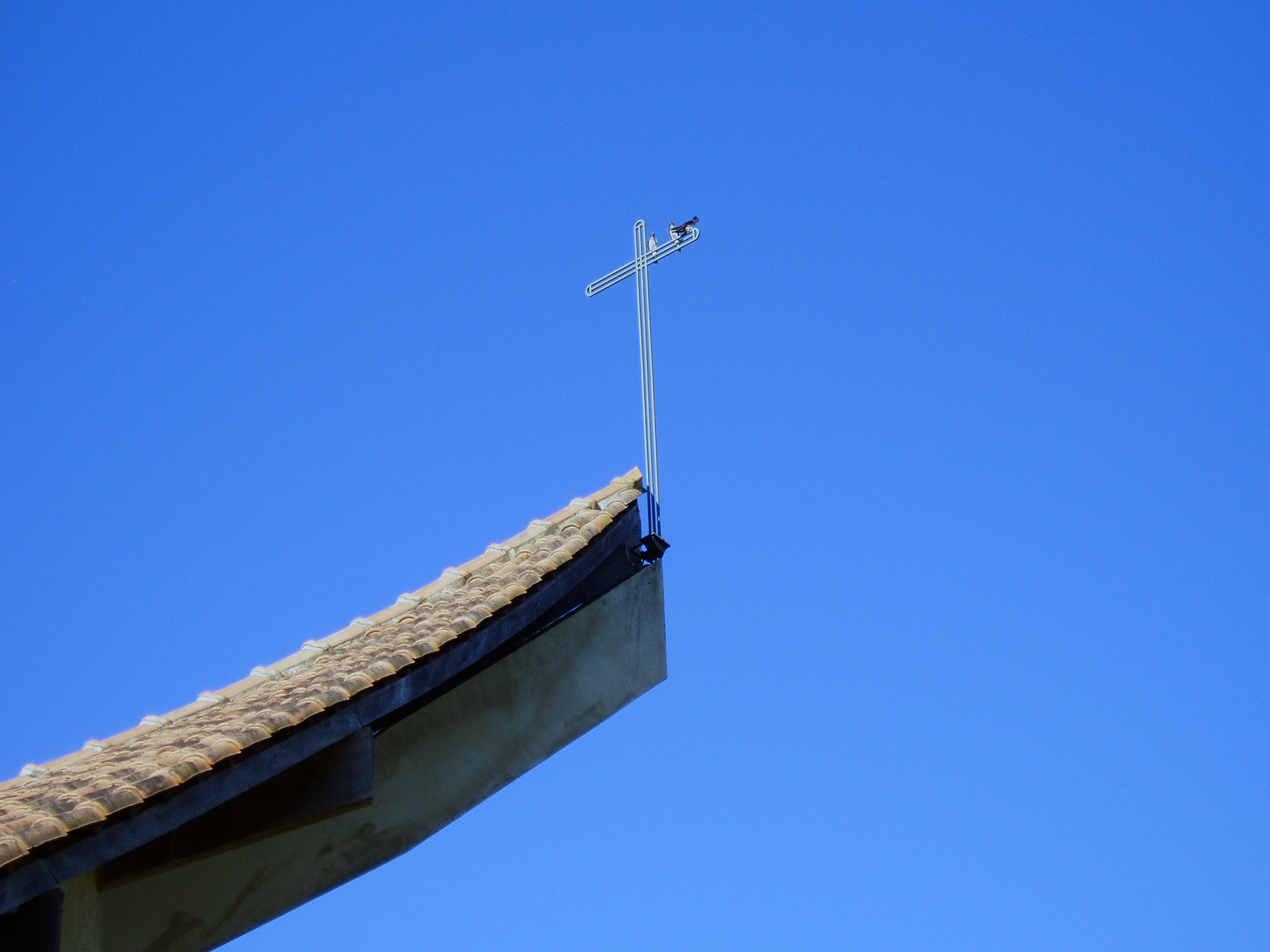 The iron crucifix stands on the roof of the Santa Filomena Chapel