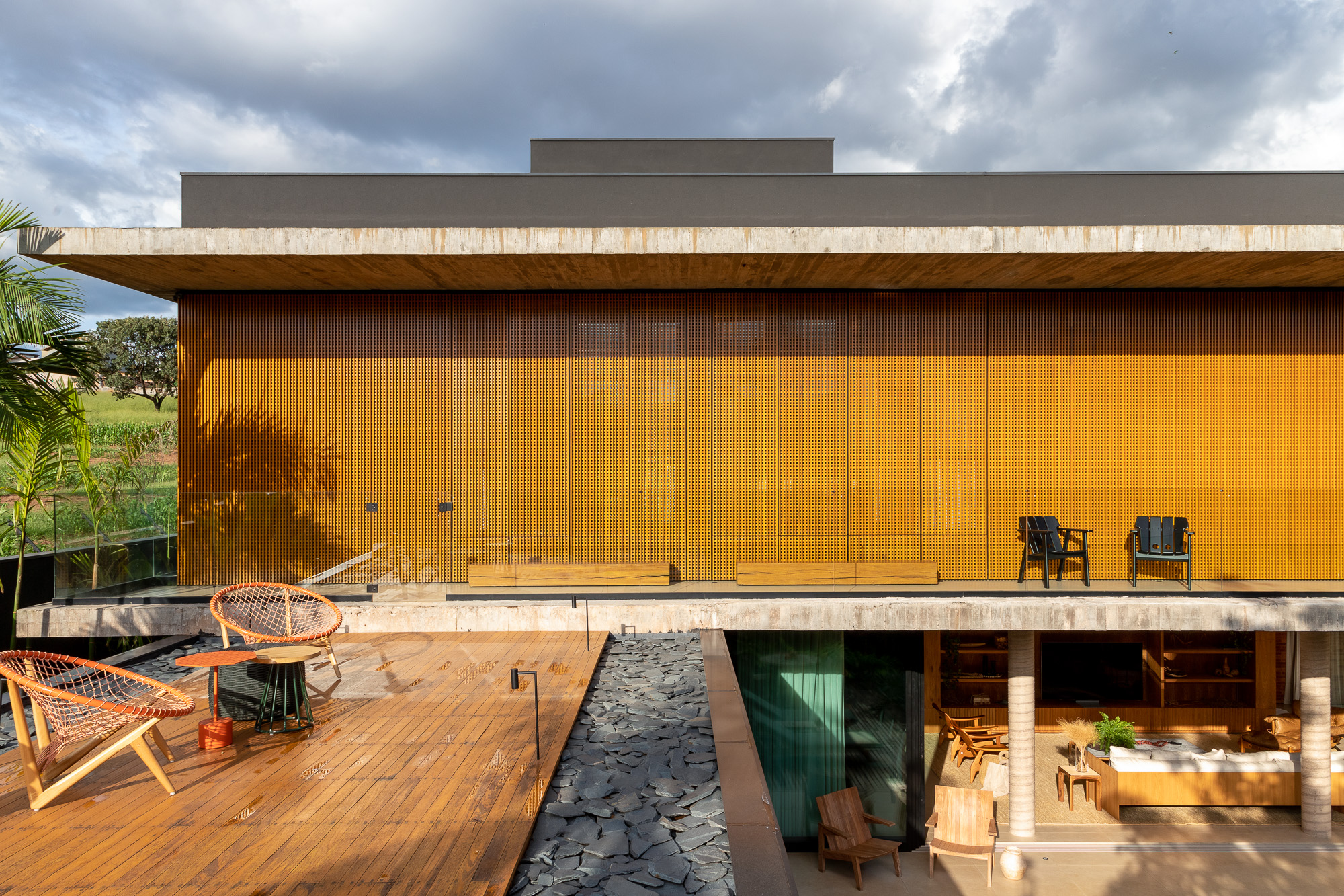 The view from the outdoor lounge on the roof deck to the facade with wooden brises when it's closed