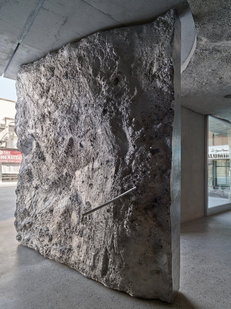 large aluminum entrance details form a sand-concrete texture