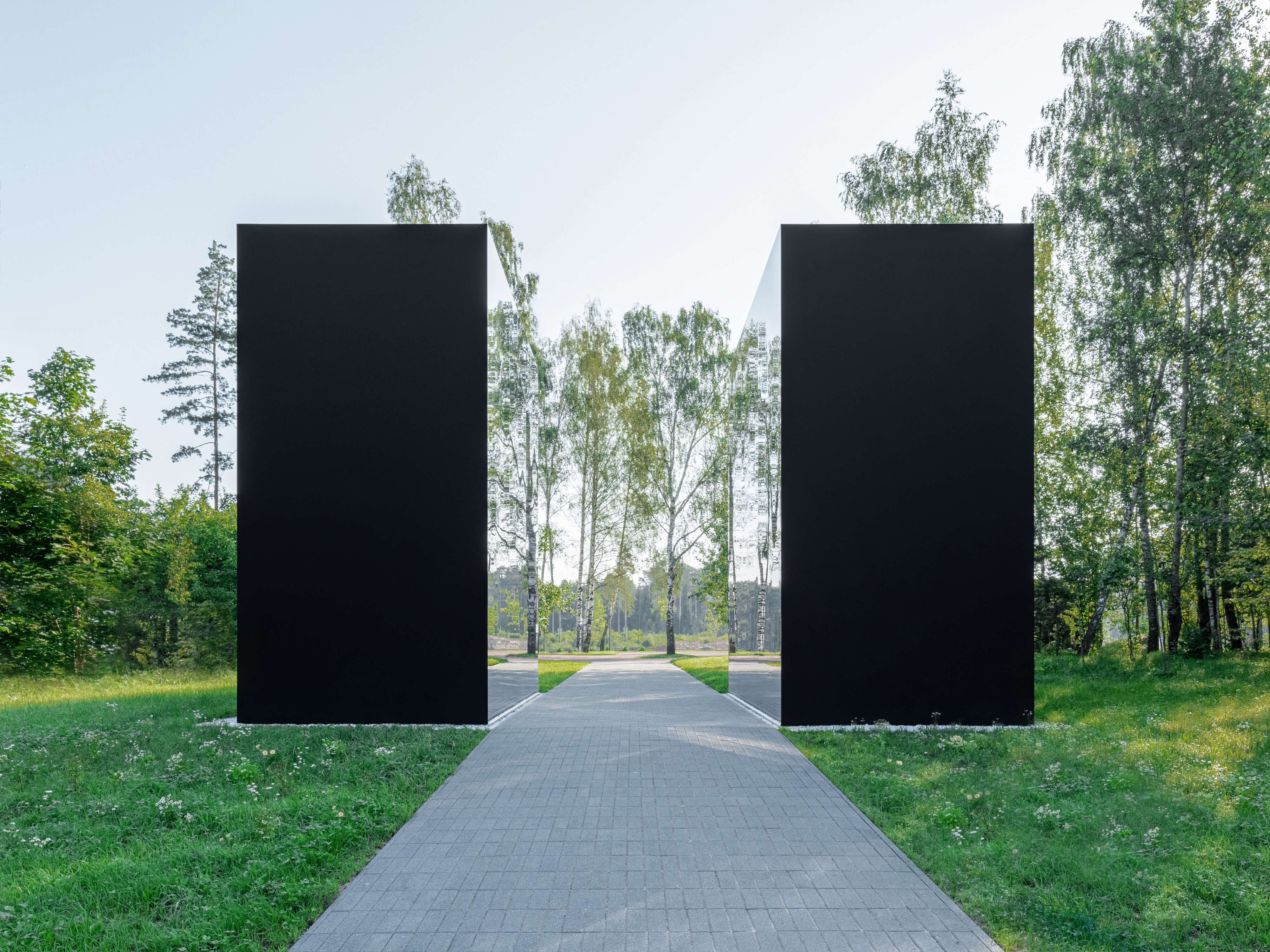 two cube structures forming a giant mirror stand opposite each other in malevich garden