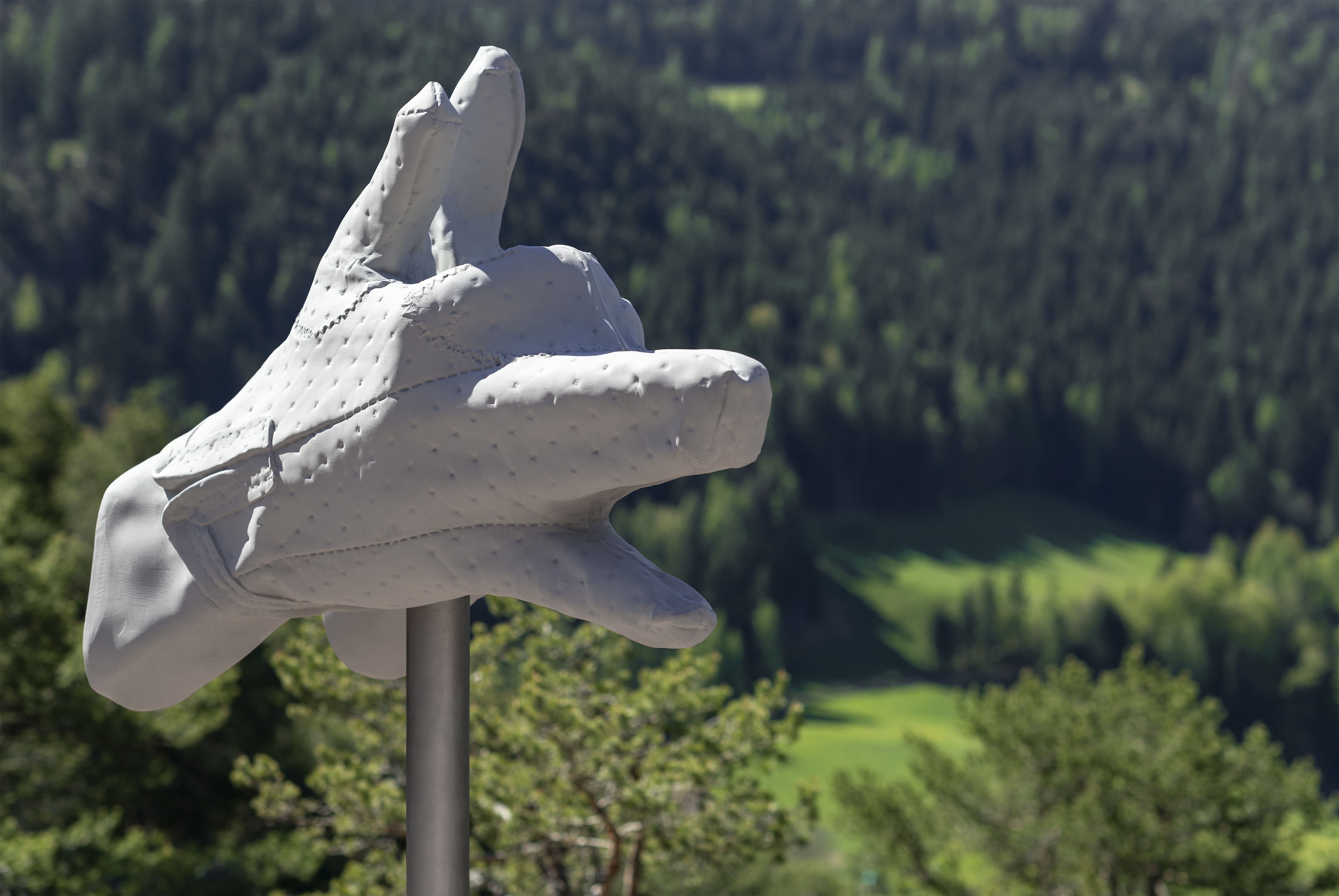 The sculpture resembles the braid of two hands and the head of a wolf at the same time