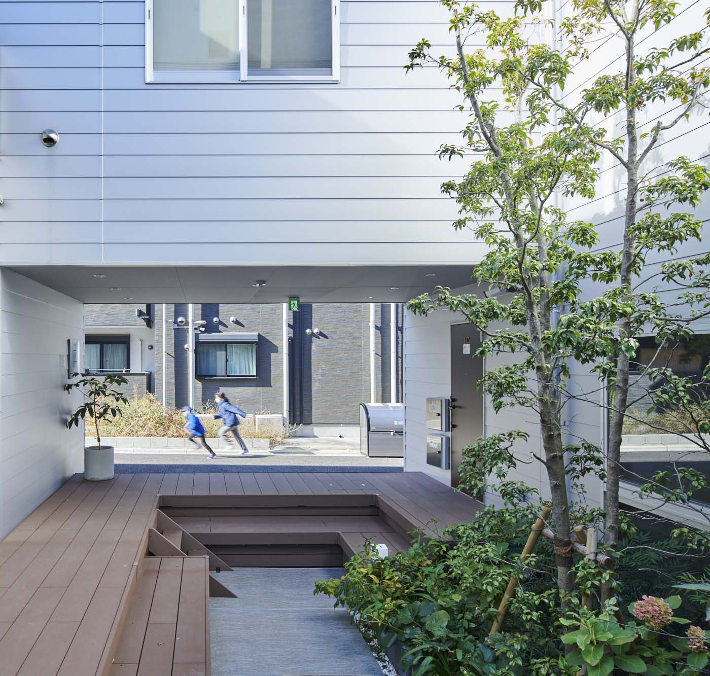 The view from the community garden within the project, which is parallel to the entrance so that it leads directly to the outside