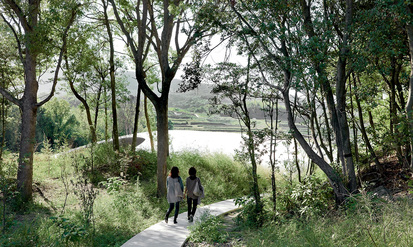 Teshima Art Museum as a white sloping structure amidst the green hills