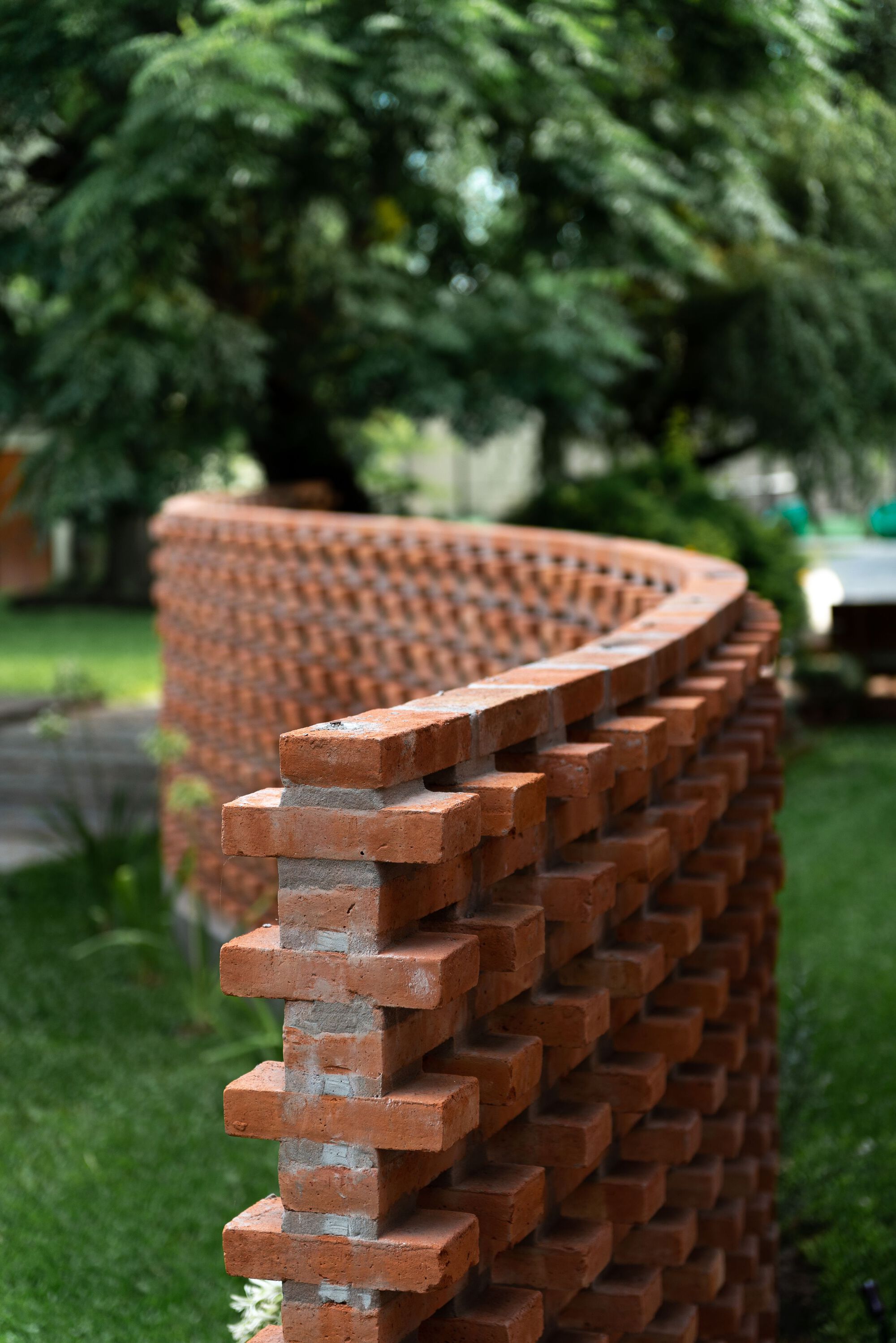 curved brick will maintain privacy while giving a homey feel and creating a peaceful visual experience when viewed