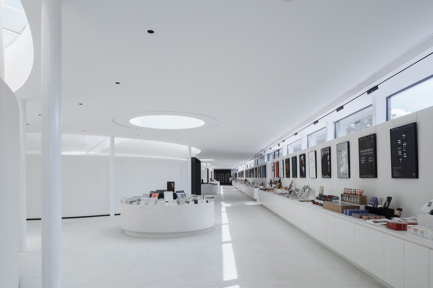 Light enters through skylights and the gap between the gallery's structure and the original building