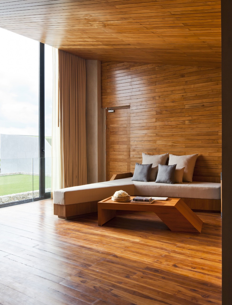 The interior of the room has a strong touch of wood on the floor to the ceiling