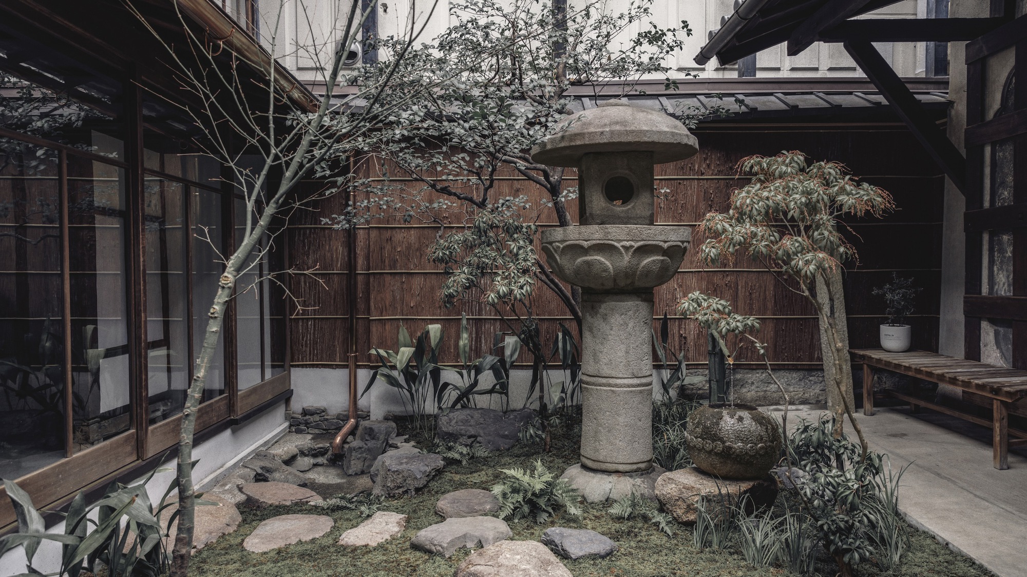 A small garden connecting the store to the cafe at Le Labo Kyoto Machiya