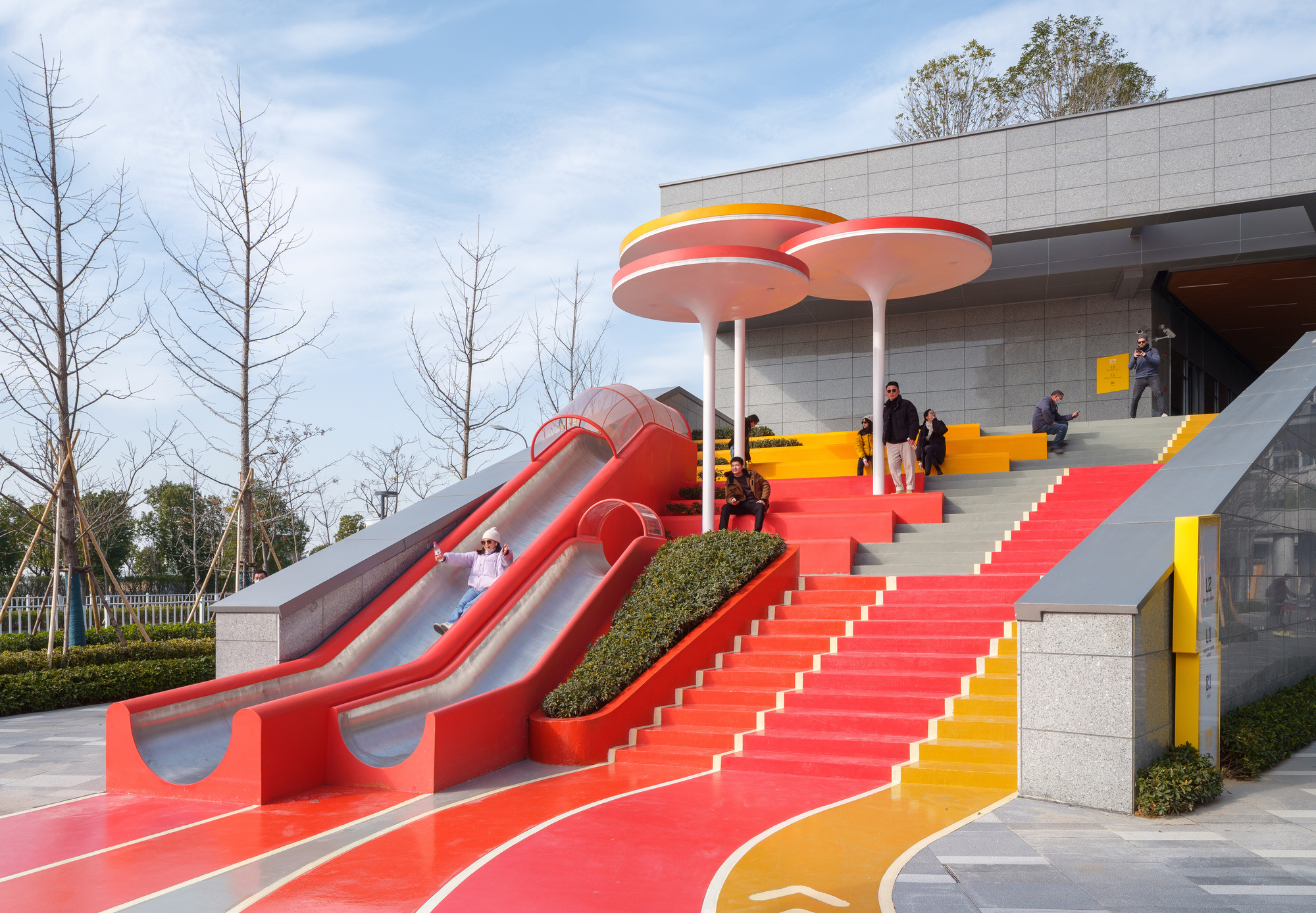 large staircase that serves as pedestrian access to the second floor, where an open commercial street is located