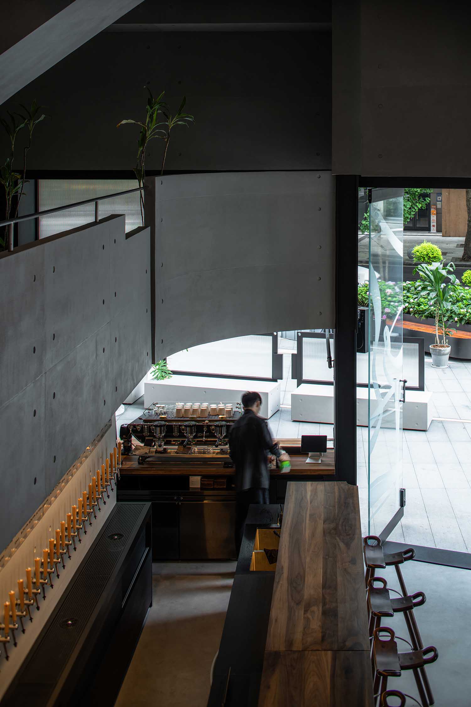 The left side is the bar area equipped with barstools and display cabinets