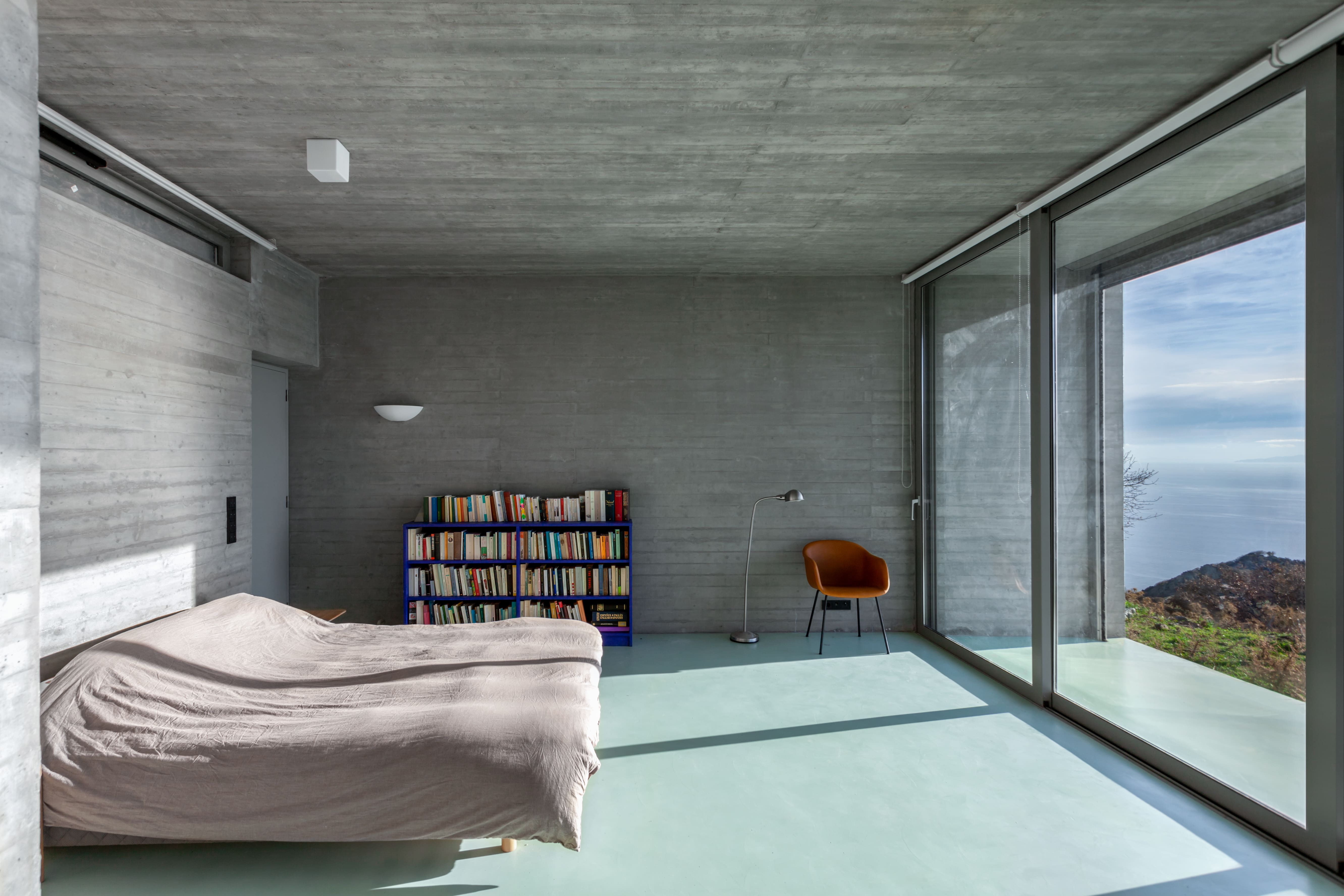 Minimalist bedroom with a bed facing the view